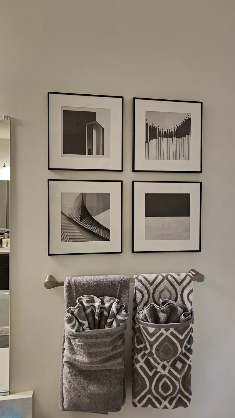 Four black-framed artworks mounted in a precisely spaced two-by-two grid
