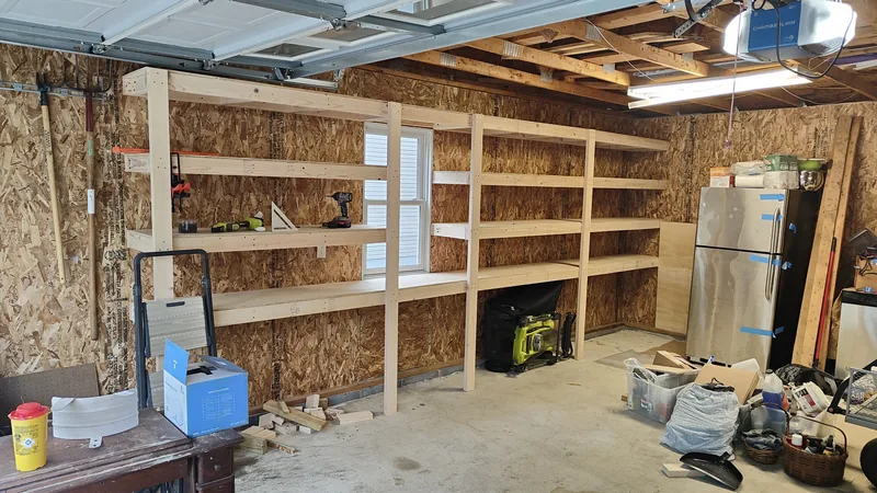Long custom timber shelving installed across an insulated garage wall